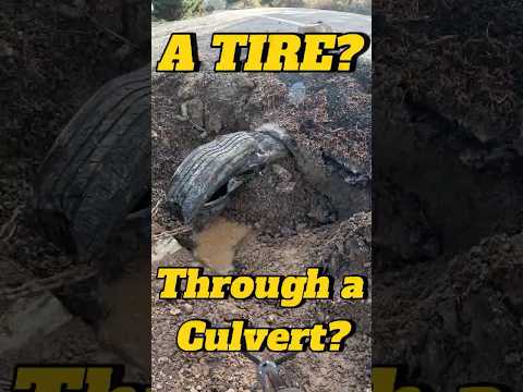 Using a tire to clean out a culvert