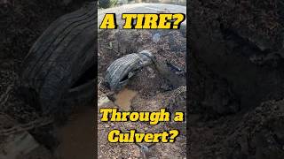 Using a tire to clean out a culvert