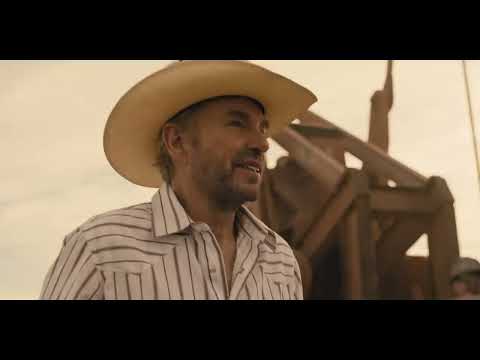 Landman trailer shot: Thornton’s character in a tense office scene under fluorescent light