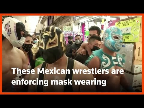 Mexico's lucha libre wrestlers take fight against COVID to vast market
