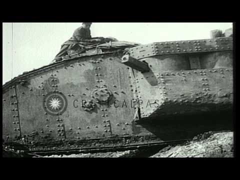 Mark I tank moves over a trench as soldiers sit on it during Battle of Arras in W...HD Stock Footage