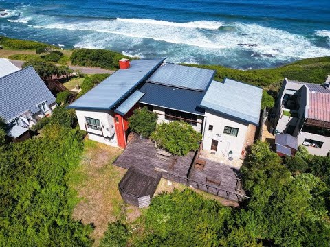 Two-story coastal residence that offers unparalleled privacy and stunning views of the sea.