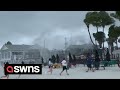 Beachgoers run for cover as waterspout turns into TORNADO | SWNS
