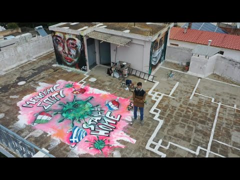 Teen graffiti artist paints COVID-19 mural on Athens roof | AFP