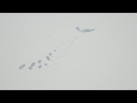 Planes parachute aid into Gaza, seen from Israel | AFP