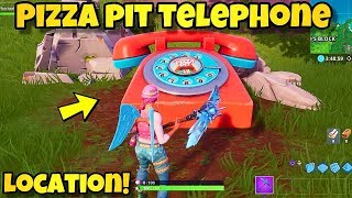 dial the pizza pit number on the big telephone east of the block location - fortnite pizza pit phone location