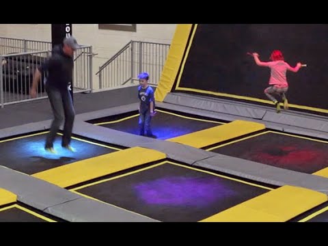 Family jumping around in a trampoline park