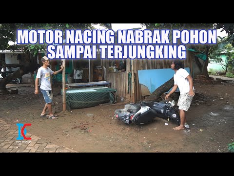 A motorcycle crashed into a tree and overturned.