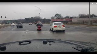 Person riding a wheelchair down Independence Blvd (US 74) - Charlotte