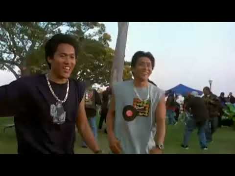 Trailer shot of nighttime quarter-mile start line with spectators and tire smoke