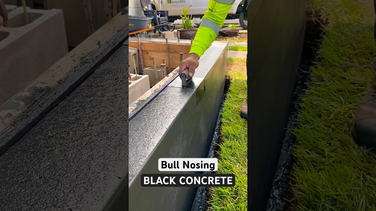 Concrete Finisher at work nosing a black concrete curb #concretefinishing #concrete #gardenborder