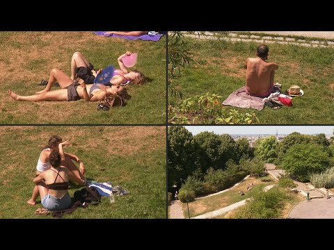 Parisians bask in parks as heatwave peaks across France | AFP