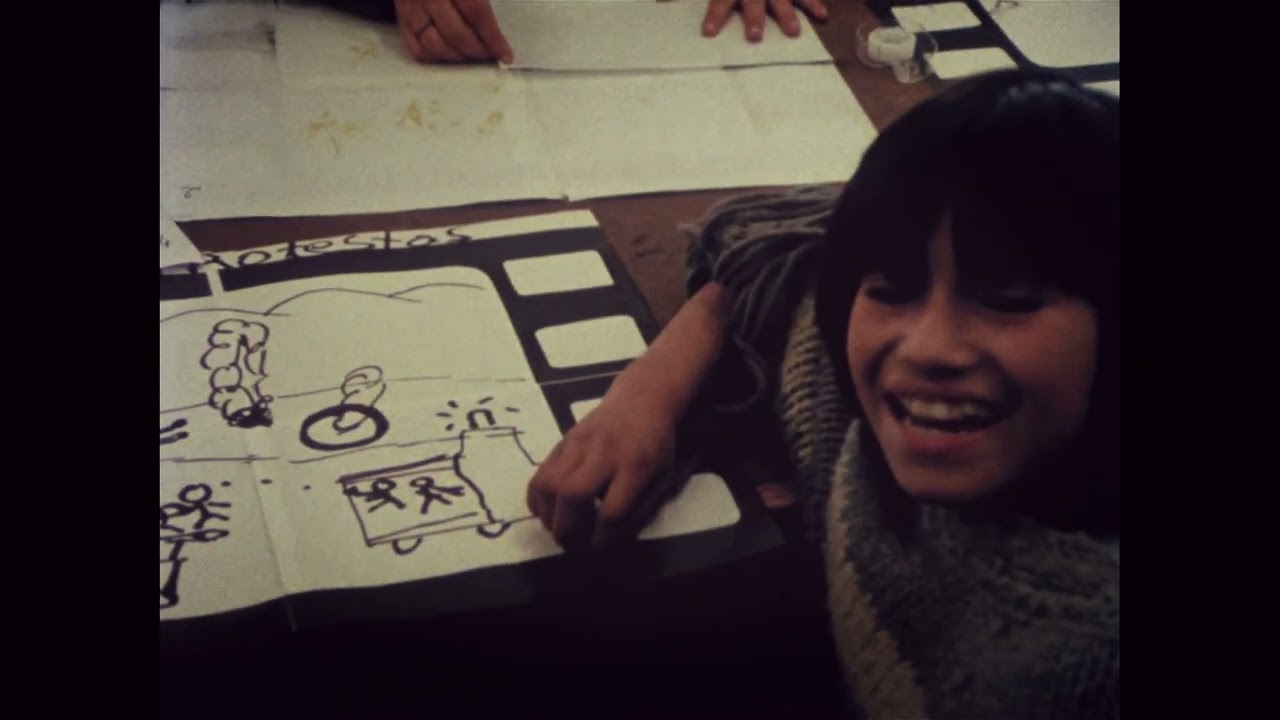 A small child holding a film camear