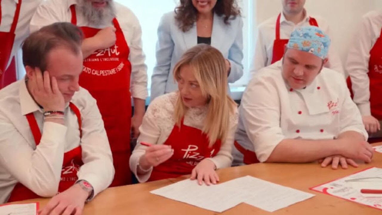 Meloni mangia la pizza da PizzAut durante la visita al ristorante a Monza per il Primo Maggio