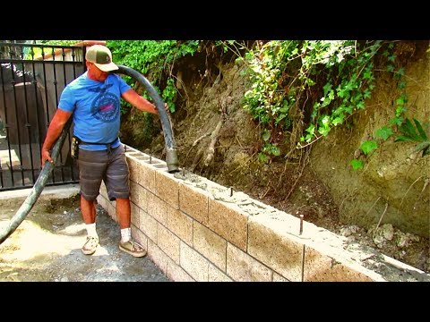 Part of a video titled How to do a split face block retaining wall California - YouTube