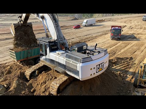 Huge Caterpillar 375 Excavator Loading Trucks