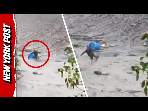 Survivor crawls through mud after flood DECIMATES town in India