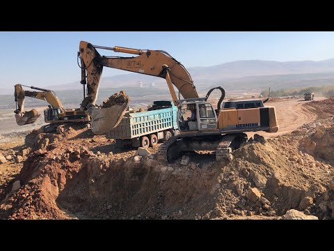 Liebherr 974 And Caterpillar 385C Excavators Loading Trucks