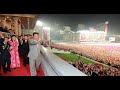 Kim Jong Un Attends Bizarre Parade With Rows Of People In Orange Hazmat Suits