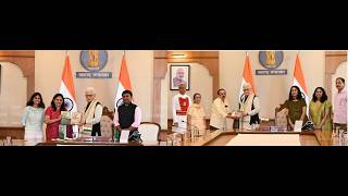 Dr. Dhanashri Hardas and Former Principal Nilkanth Namjoshi present books to Governor