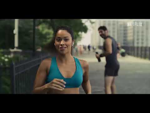Official trailer frame: Gina Rodriguez and Damon Wayans Jr. in a New York bar as a pop groove kicks in