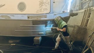 Removing paint and crap off this boat ready for ReCoating