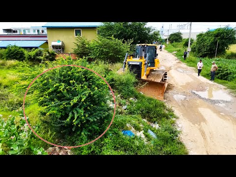 Amazing bulldozer clearing dirt and trash filling land with dump trucks