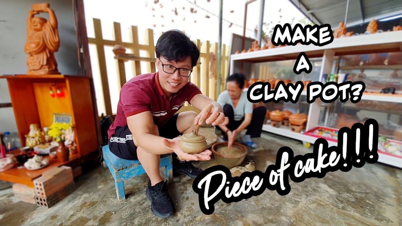 A tourist visits Thanh Ha Pottery Village, marveling at the artisans' craft.
