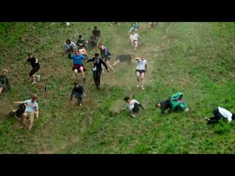 Thrill-seekers roll down a hill in British cheese chase | REUTERS