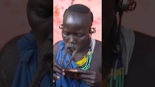 Woman from Surma tribe inserts lip plate  Omo Vall