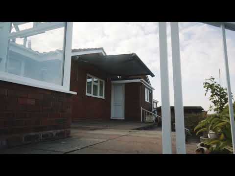 Weinor Semina Life remote awning with front valance and spreader weight plates.