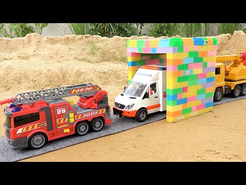 Construction vehicles pass through the magic gate with fire truck and crane truck toys
