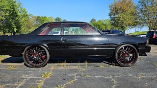 1987 Chevrolet Malibu on 24' Forgiatos with a custom Red Interior and a Beautiful Black paint job 🔥