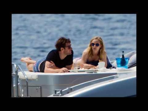 Emily Blunt dons a skimpy hot pink bikini as she leans in for a kiss with husband