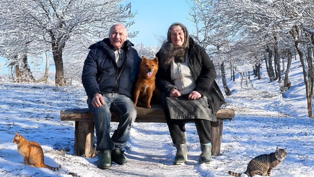 Happy old age of an elderly couple in a village in winter far from civilization