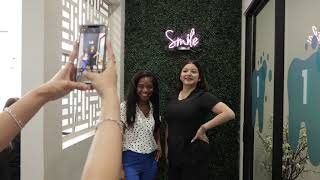 Person taking a photo of two women in Dallas dental office