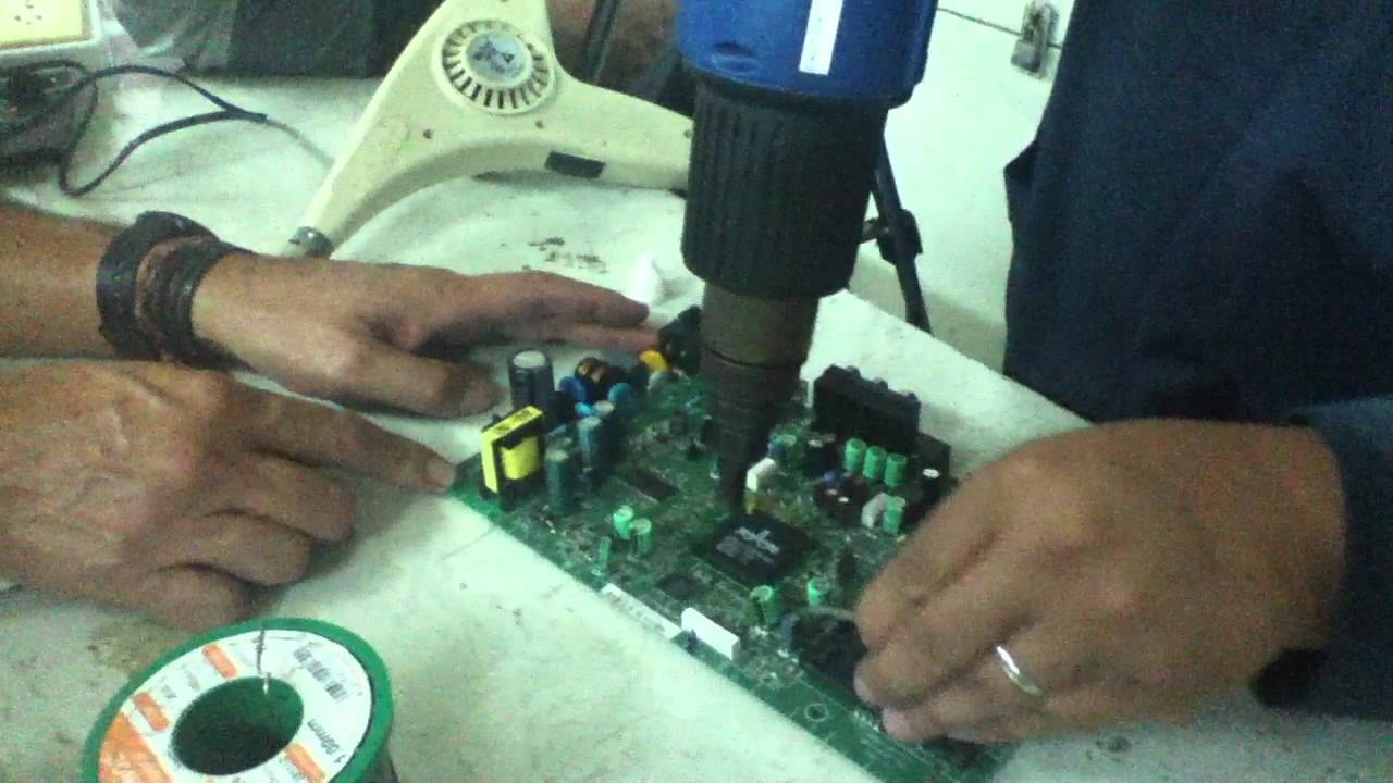 Jairo retirando un C.I con pistola de aire caliente.