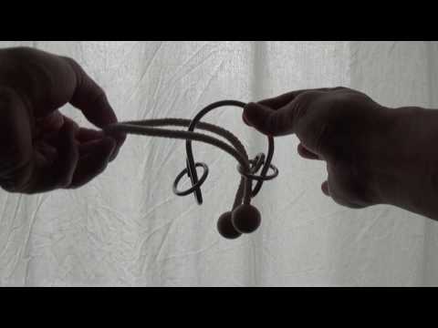 Disentanglement puzzle 5 - Rack (rope with balls attached at both ends)