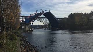 Seattle Fremont bridge opens to let a small sailboat through.