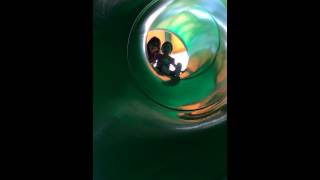 Going down the big green tube slide.