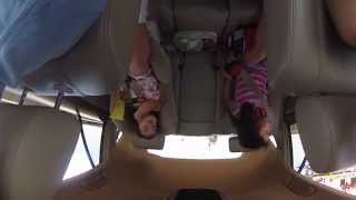 2 little girls sing along to Homeboy Sandman's "Listen" while driving over a bridge