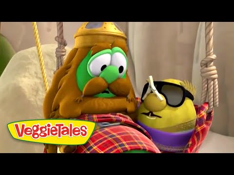 Two VeggieTales characters—a green cucumber with a Viking-style helmet and mustache, and a yellow pepper wearing sunglasses and a purple scarf—tied to ropes on a set, VeggieTales logo visible.