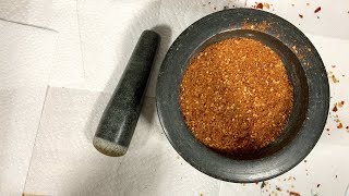 Using a mortar and pestle to grind out your own hot pepper spice blends
