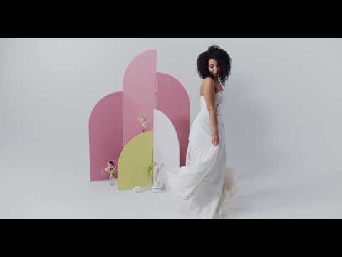 Woman in a white dress dancing.