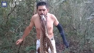 Man hangs six SNAKES from his MOUTH while standing on SPIKES!