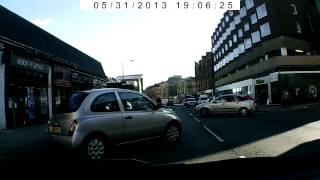 Death wish cyclist has a near miss with a reversing car