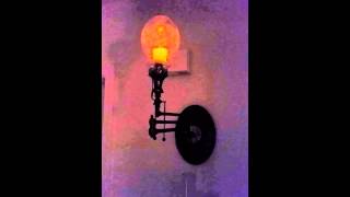 Antique gas wall sconce with battery candle.