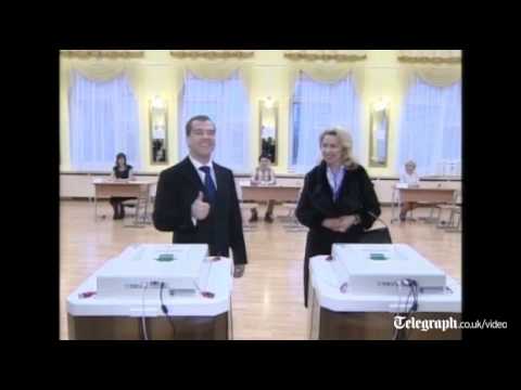 Russian President Dmitry Medvedev and Prime Minister Vladimir Putin vote