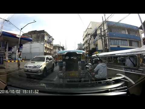Jeepney talks to somebody while in the middle of the road