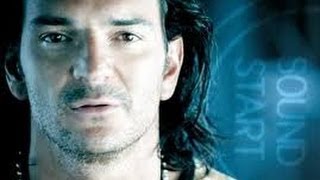 RICARDO ARJONA: A Cara O Cruz; man walks in water